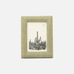 A textured green photo frame displays a black-and-white image of cacti in a desert landscape.