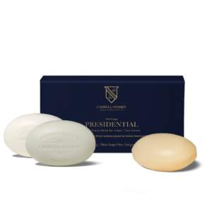Three bars of soap in front of a blue box labeled "Presidential" by Caswell-Massey.