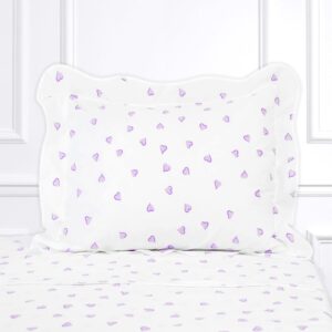White bedding with a lavender heart pattern on the pillow and sheets, set against a light background.