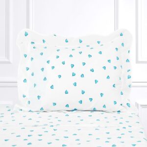 White bed linen with a turquoise heart pattern on the pillow and sheet.