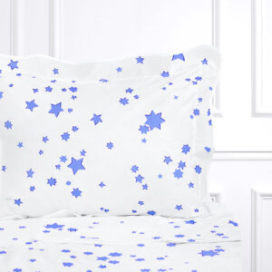 White bedding with blue star patterns on a pillow and sheet.
