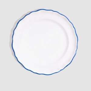 White dinner plate with a blue scalloped edge, centered on a gray background.