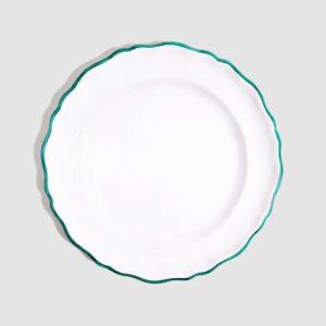 White dinner plate with a scalloped edge and green trim, centered on a light gray background.