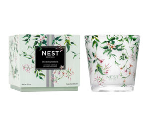 Scented candle in decorative glass jar beside its floral-patterned box, labeled "Indian Jasmine.