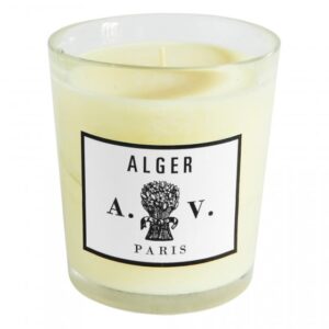 A glass candle with a white label reading "ALGER A.V. PARIS" and a floral design.