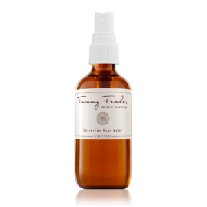 Brown glass spray bottle of Bulgarian Rose Water with a white label and spritzer top.
