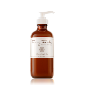 Brown glass bottle of Tammy Fender Cleansing Milk with a pump top, labeled 6 oz.