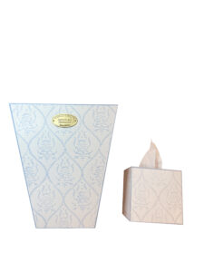 Pale blue wastebasket and tissue box with floral patterns, featuring a gold label.
