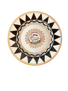 Ceramic plate featuring a central lion design, surrounded by geometric patterns in black and white.