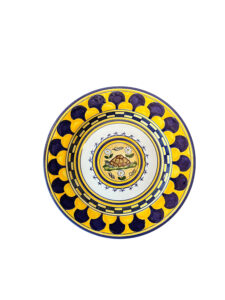 Ceramic plate featuring a turtle design, surrounded by colorful floral and geometric patterns.