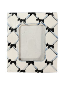 A decorative picture frame featuring a pattern of black Scottie dogs on a white background.
