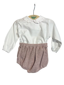 White long-sleeve top with a scalloped collar paired with pink textured bloomers.