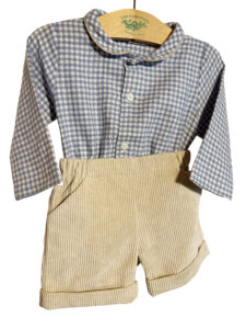 Blue and white checkered shirt with beige corduroy shorts, displayed on a wooden hanger.
