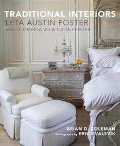 Cozy bedroom scene featuring a white bed, armchair, and decorative nightstand with a lamp and flowers.