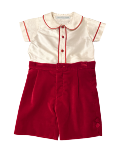 Short-sleeve cream shirt with red trim and red velvet shorts, featuring buttons on the side.