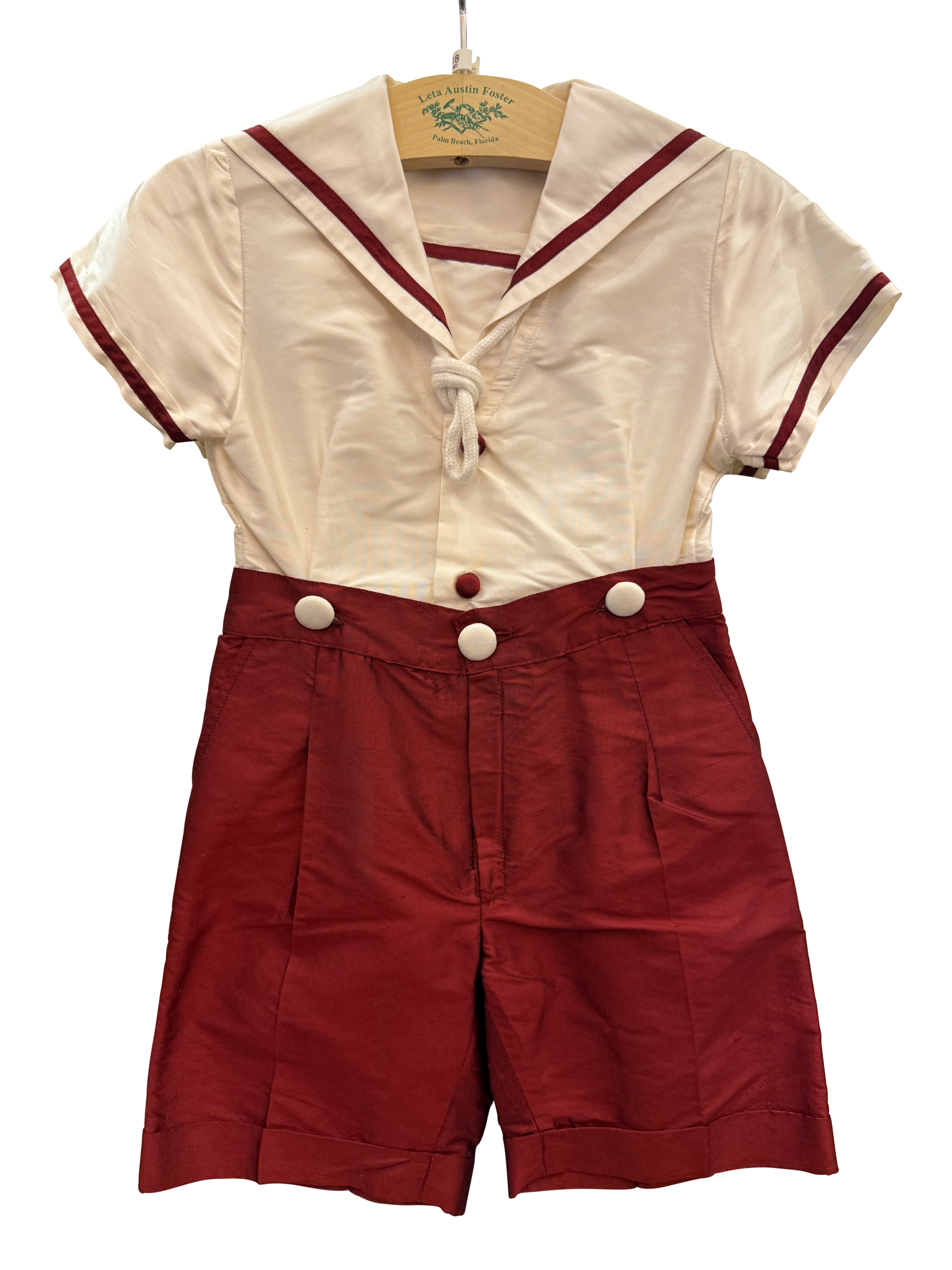 Baroni Silk Boy Sailor Set Sailor-style outfit featuring a white top with red trim and matching red shorts, displayed on a hanger.