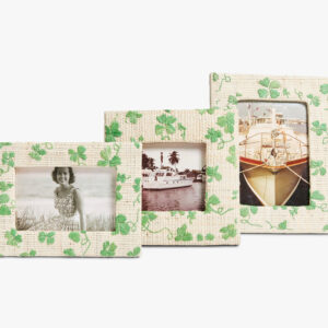 Three decorative photo frames with green clover patterns display black-and-white images of a woman and boats.