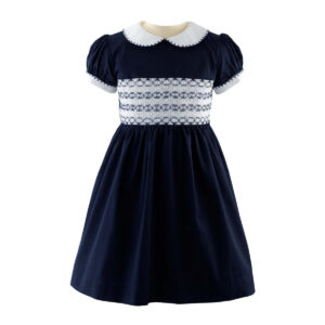 Navy blue smocked dress with white collar and puffed sleeves, featuring decorative stitching on the bodice.