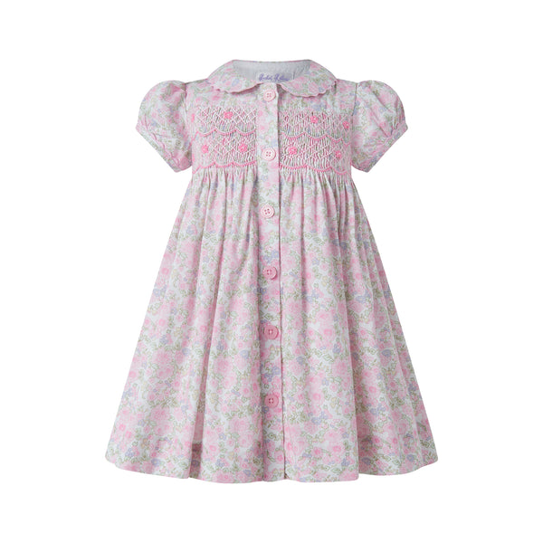 IDR574PKAGA_A_600x Light pink dress with short puff sleeves, smocked bodice, and floral pattern. Features a button-down front.