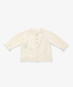 Cream cardigan with three buttons and rolled sleeves, featuring a textured pattern.