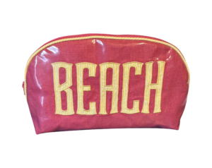 Round pink and yellow beach bag with "BEACH" printed in bold letters.