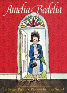 A woman in a blue coat stands at a doorway, smiling. The background features a colorful stained glass window.