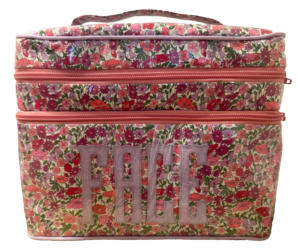 Floral-patterned double zip bag with pink accents and the word "FACE" prominently displayed.