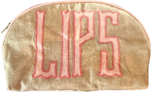 Natural fabric pouch with pink "LIPS" lettering on the front. Zipper closure at the top.