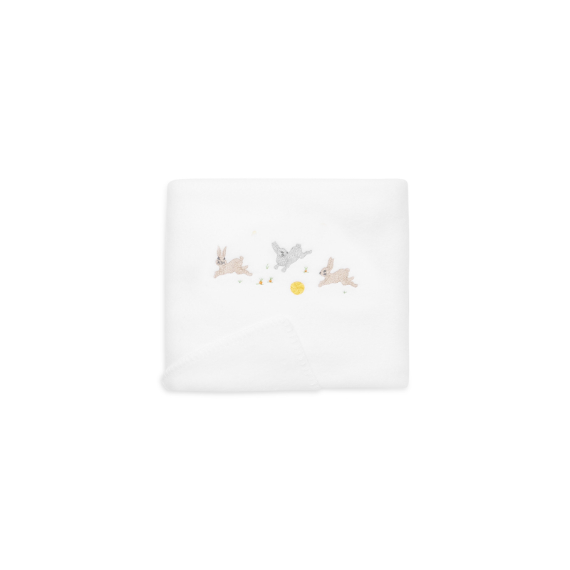 rabbits-fleece-blanket White fleece blanket featuring embroidered rabbits and a sun.