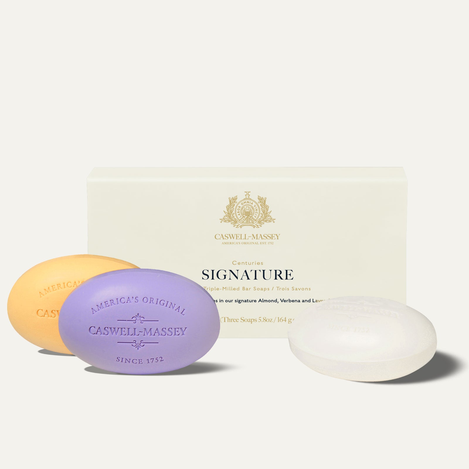 Three oval bar soaps in a box, featuring almond, verbena, and lavender scents.