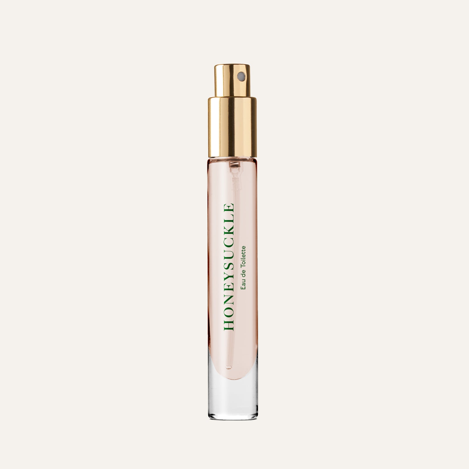 Clear glass perfume bottle with a gold spray nozzle, labeled "HONEYSUCKLE Eau de Toilette.