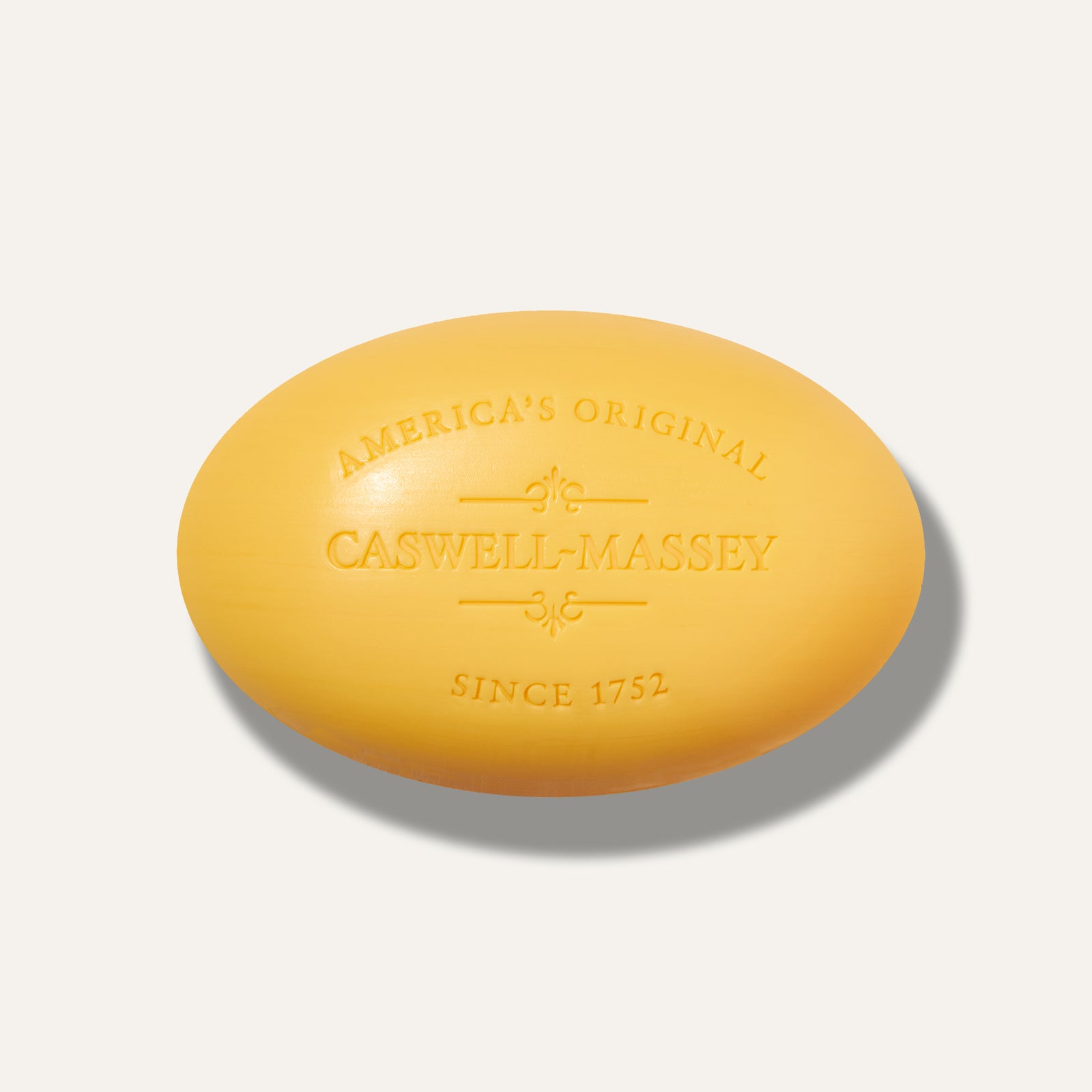 Yellow oval soap with "Caswell-Massey" and "America's Original" embossed on the surface.