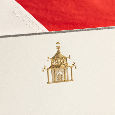 Gold pagoda illustration on a white note card, with a red envelope partially visible in the background.
