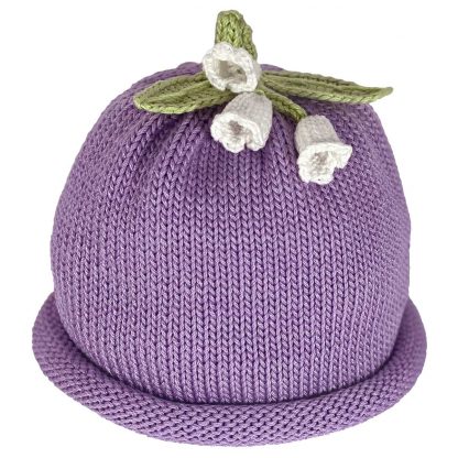 Purple knitted hat with a rolled brim and three white flower embellishments on top.